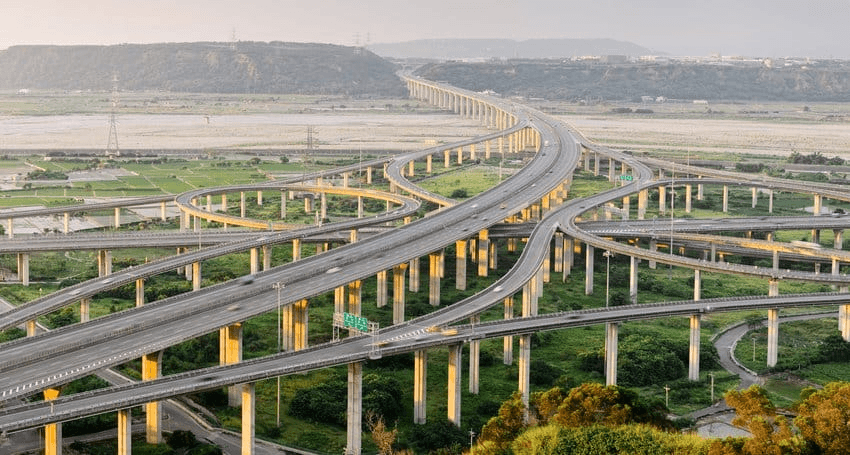Aerial view of a multi-level highway interchange — the infrastructure Metro Associates staffs